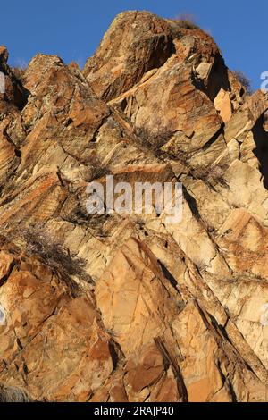 Layered rocks and hills. Surface of a natural stone brown colour Stock Photo