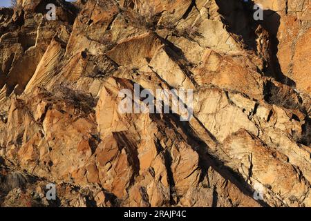 Layered rocks and hills. Surface of a natural stone brown colour Stock Photo