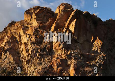 Layered rocks and hills. Surface of a natural stone brown colour Stock Photo