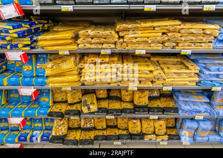 Italy - December 10, 2021: Pasta in different types and brand in packages displayed on the shelf for sale in Italian Supermarket Stock Photo