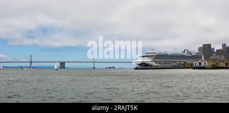 Ruby Princess cruise ship docked and Bay Bridge San Francisco California USA Stock Photo