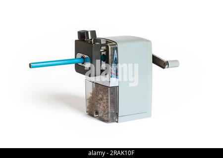 Mechanical rotary pencil sharpener and blue pencil, isolated on a white background, UK Stock Photo