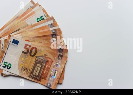 close-up on a white background spread out like a fan a lot of money euro 50 bills.with the right there is a place for an inscription money background Stock Photo