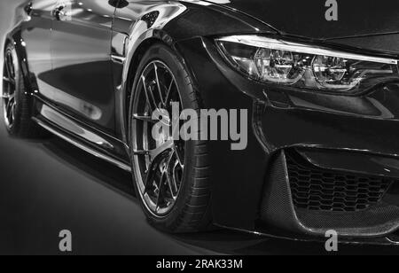 Front headlights of black modify car on black background Stock Photo