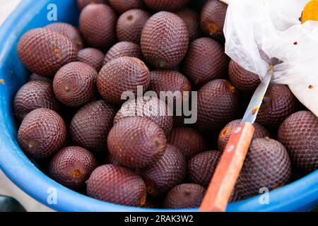 The aguaje is the fruit of a palm tree widely cultivated in the humid areas of South America. This can be eaten fresh and is very nutritious. Stock Photo