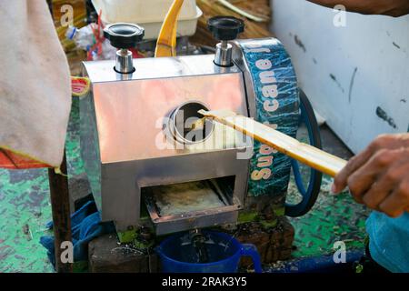 Sugar cane juice made with a machine in a street market in Peru Stock Photo