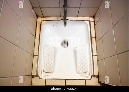 A squat or squatting toilet in France, sometimes known as Turkish toilets. Stock Photo