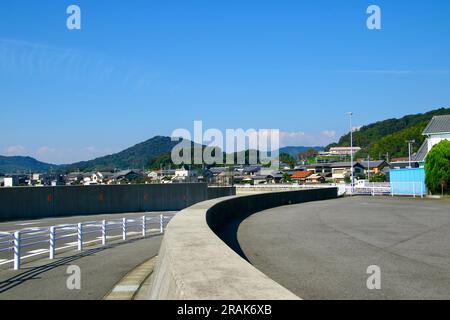 A wonderful autumn view of blue skies, tree-covered mountains and seaside living from a unique perspective Stock Photo