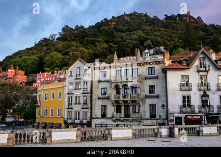 The pastel colored buildings of the historic town centre and central square of Sao Martinho, in Sintra, Portugal. The Romanticist architectural and fairytale palaces draws tourists from around the world. Stock Photo