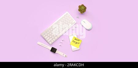 Sticky note with text DON'T FORGET and modern gadgets on lilac background Stock Photo