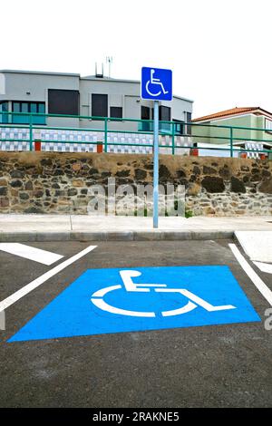 International Symbol of Access (ISA) on a parking lot for handicapped drivers located in a residential area. Stock Photo