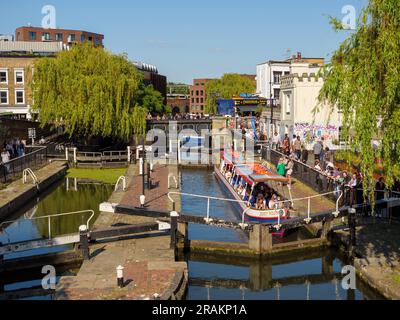 Narrowboat cruise passing through the locks on the Grand Union Canal at Camden Town, London, UK Stock Photo