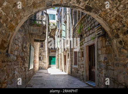 A typical covered, narrow alleyway in the  Medieval old town next to the walls of Diocletian's Palace in Split, Dalmatia, Croatia. Stock Photo