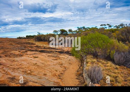Low walls to guide rainwater from a granite outcrop in the outback to a reservoir. Boondy Rock, Goldfields Woodlands National Park, Western Australia Stock Photo