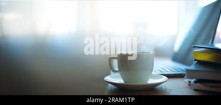 Modern office workplace with laptop computer, coffee cup and office supplies Stock Photo
