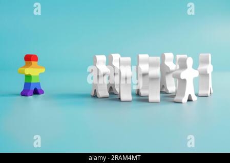 A lot of white figurines and one colored figurine as symbol of diversity Stock Photo