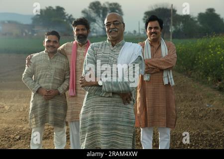 Beautiful portrait composition of Indian farmers standing in field. Agriculture concept portraying farmers attitude. Farmer Agricultural benefits. Stock Photo