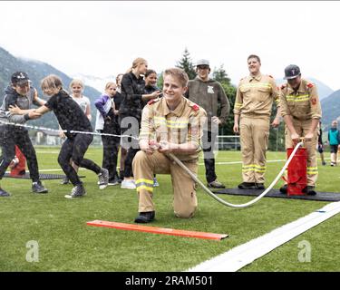 AUSTRIA, BAD HOFGASTEIN - July 1, 2023: Uniformed firefighters teach children how to put out a fire Stock Photo