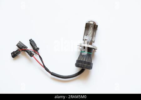 Xenon lamp for a car on a white background close-up, headlight repair and replacement Stock Photo