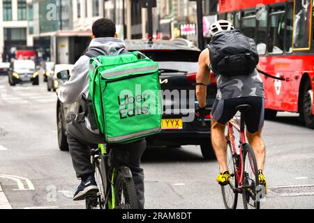 London, England, UK - 28 June 2023: Cyclist carrying an insulated delivery container for the Uber Eats food delivery business cycling in London Stock Photo