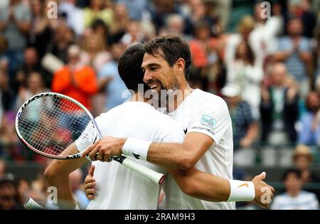 Wimbledon. Carlos Alcaraz of, Spain. 04th July, 2023. receives an embrace from opponent Jeremy Chardy of France following their first round match at Wimbledon, Alcaraz won the match in straight sets. Credit: Adam Stoltman/Alamy Live News Stock Photo