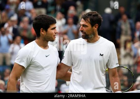 Wimbledon. Carlos Alcaraz of, Spain. 04th July, 2023. receives congratulations from opponent Jeremy Chardy of France following their first round match at Wimbledon, Alcaraz won the match in straight sets. Credit: Adam Stoltman/Alamy Live News Stock Photo