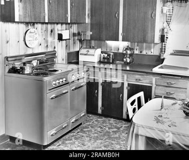 https://l450v.alamy.com/450v/2ramb0h/united-states-c-1959-a-wood-paneled-kitchen-with-a-wall-mounted-can-opener-and-coffee-grinder-and-a-sunbeam-vacuum-drip-coffee-percolater-2ramb0h.jpg