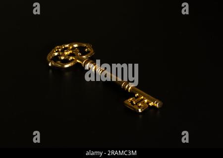 Vintage golden key isolated on black background Stock Photo