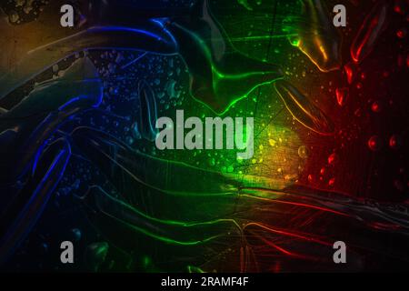 High res macro detail of transparent plastic foil packaging on black surface, design mock up, with rainbow colors , vacuum sealed pouch. Stock Photo