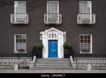 Old fashioned Georgian style townhouse with bright blue front door Stock Photo