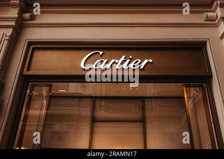 Golden logo Cartier at facade entrance to boutique fine jewelry watches bridal sets shop accessories and fragrances store. It was founded in 1847 by L Stock Photo