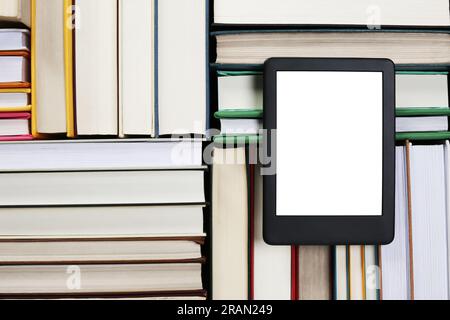Portable e-book reader on different hardcover books, top view Stock Photo