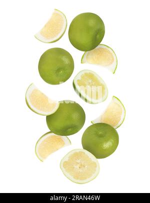 Cut and whole fresh sweetie fruits falling on white background Stock Photo