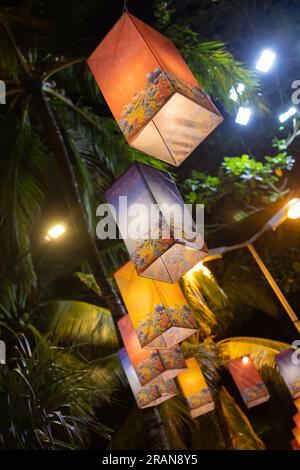 Lanterns decorated with marine animal motifs, purple, orange, several at night. Stock Photo