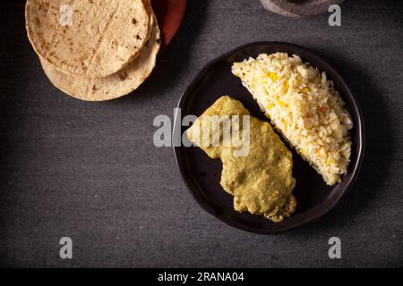 Pipian, also known as Mole Verde, food from Mexico and other Latin American countries, chicken meat bathed in mole sauce made with pumpkin seeds, drie Stock Photo