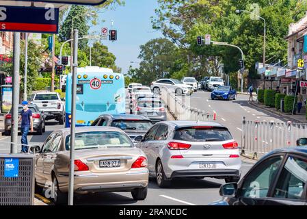 Looking south on the Pacific Highway at Gordon on Sydney Australia's north shore as heavy traffic waits at a red light on a weekday Stock Photo