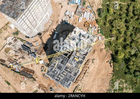 construction site. tower crane and construction machinery. housing development. aerial top view from drone. Stock Photo