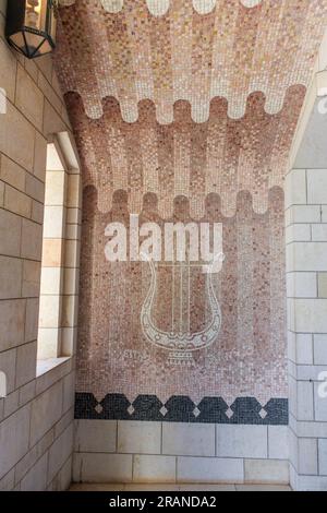 This mosaic on the wall of the Basilica of the Annunciation in Nazareth, Israel portrays a musical instrument known as a cithara, or kithara. Stock Photo