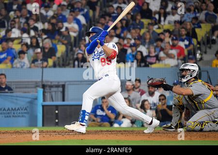 Los Angeles Dodgers' Jonny Deluca, center, is congratulated by Miguel  Rojas, right, after scoring on a balk as Houston Astros catcher Yainer Diaz  kneels at the plate during the eighth inning of