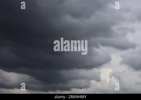 Dark ominous grey storm clouds. Dramatic sky Stock Photo
