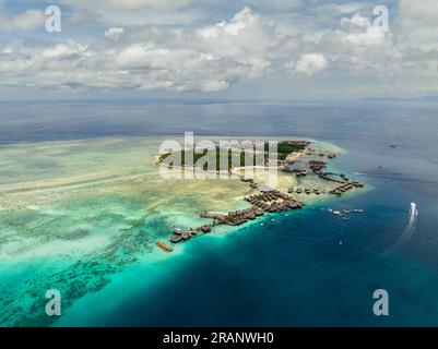 Aerial drone of tropical island of Mabul with a beautiful beach and coral reef. Semporna, Sabah, Malaysia. Stock Photo