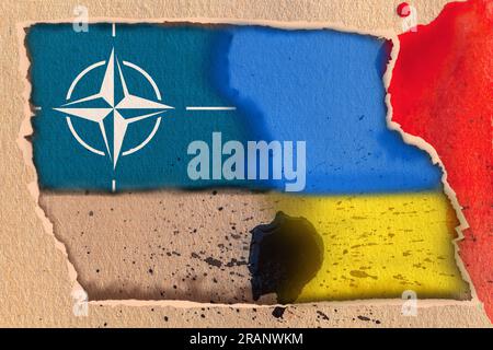 Flag of the NATO North Atlantic Treaty Organization and the flag of Ukraine on an abstract background of torn textured paper with stains. Stock Photo