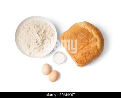 Fresh homemade bread with a crispy crust, prepared in an automatic bread maker and baking ingredients, isolated on a white background, top view. Stock Photo