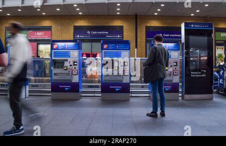 London, England, UK. 5th July, 2023. A passenger buys a ticket on a self-service machine at a rail station in London. Industry body the Rail Delivery Group (RDG) has set out plans to close nearly every railway ticket office in England over the next three years as most travellers now purchase tickets online and via machines at stations. The plans have come under fire due to the impact on jobs and vulnerable passengers. (Credit Image: © Vuk Valcic/ZUMA Press Wire) EDITORIAL USAGE ONLY! Not for Commercial USAGE! Stock Photo