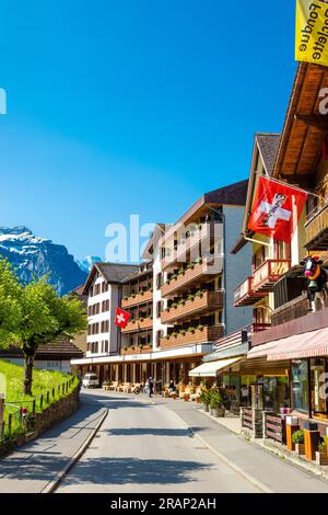 Swiss style chalets, hotels and restaurants along main street (Dorfstrasse) in Wengen, Switzerland Stock Photo