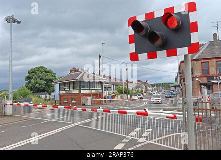 NI Railways train passes level crossing safely at Bushmills Rd, Coleraine, Northern Ireland, UK,  BT52 2BN Stock Photo