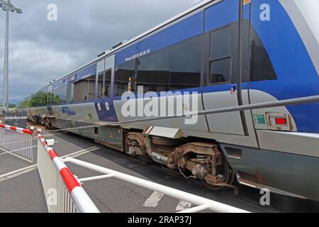 NI Railways train passes level crossing safely at Bushmills Rd, Coleraine, Northern Ireland, UK,  BT52 2BN Stock Photo