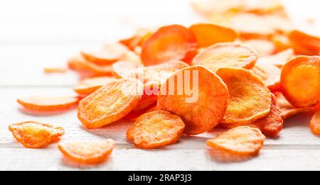 Dried vegetables chips from carrot. Organic diet and vegan food. Stock Photo