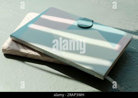 Two notebooks with shadows on grey background Stock Photo