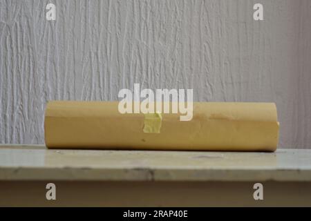 roll of old paper on a wooden table Stock Photo